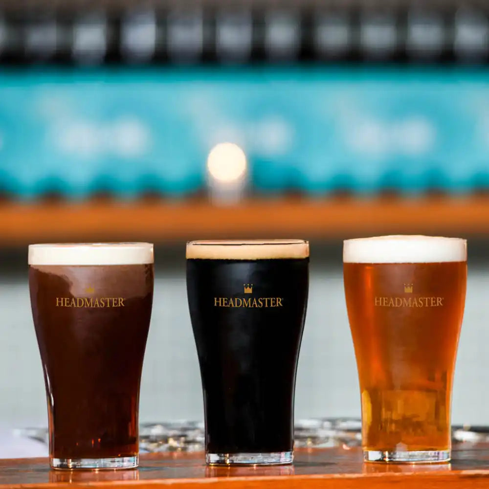 Three headmaster beer glasses of beer in different shades.